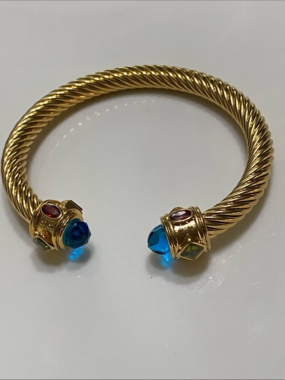 Gold Twisted Cuff Bracelet with Blue Gem Cabochon